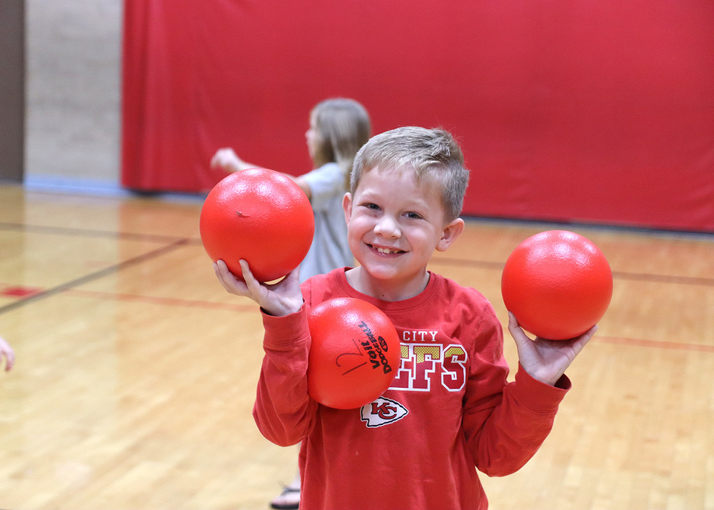 Second grader McKinley Packebush plays dodgeball with the high schoolers. Photo by Linda Drake