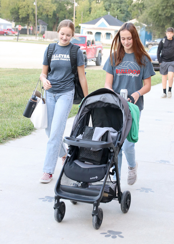 Sophomore Kadence Gerber and senior Leah Francis walk to school on anything but a backpack day. Photo by Linda Drake