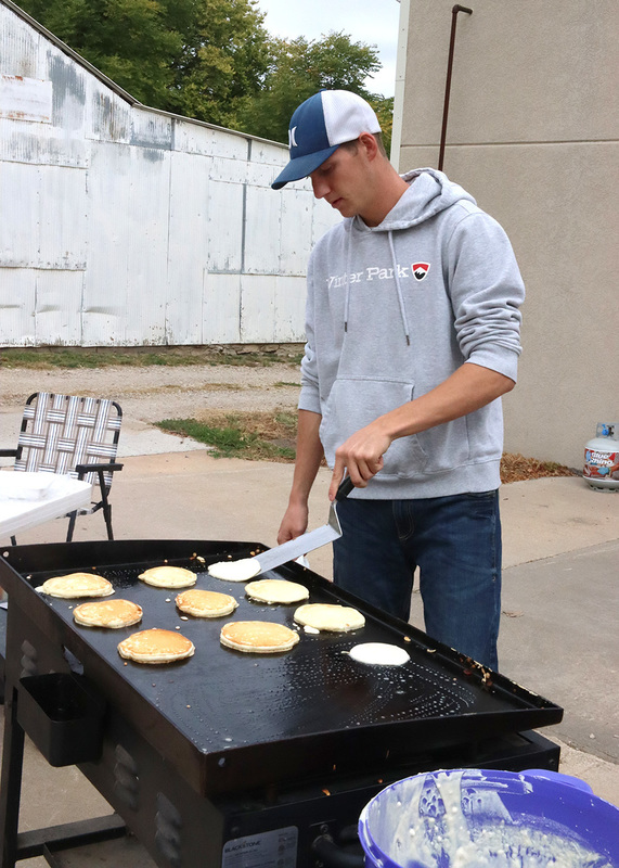 Senior Cooper Schroer flipping pancakes. Photo by Linda Drake