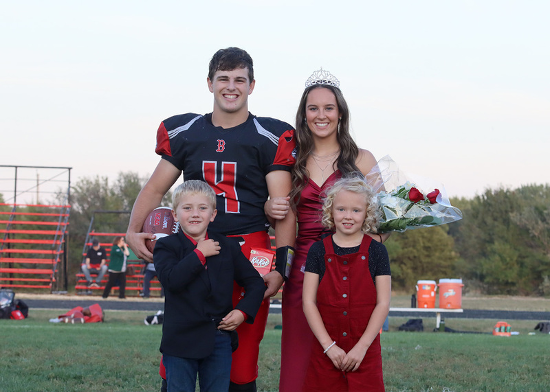 Homecoming winners quarterback Mitchell Budke and Grace O'Brien pose with little cupids for Homecoming. Photo by Karsen Vandegrift