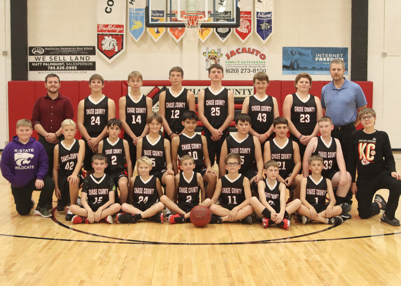 Junior high boys pose for team pictures with managers and coaches. Photo by Kinslea Glanville