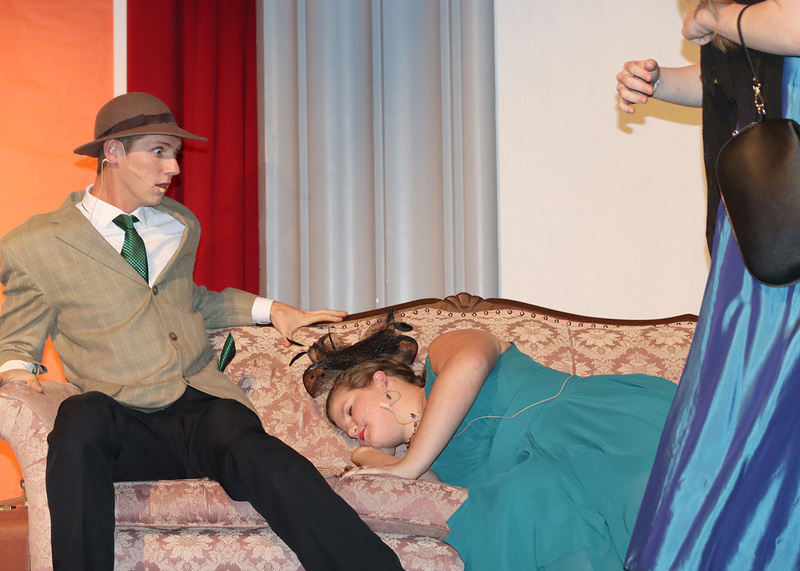 Senior Cooper Schroer and sophomore Lydia Filinger act out a scene from the play on stage. Photo by Avia Banks