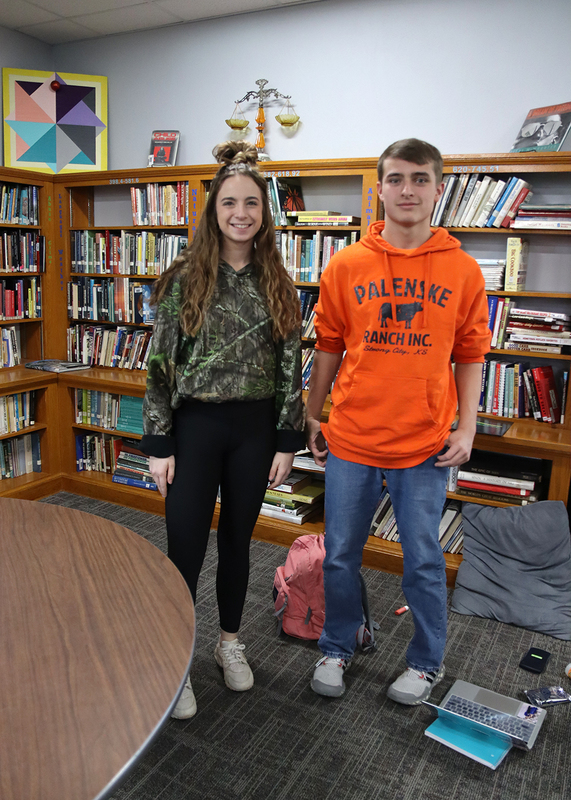 Seniors Emily Miser and Taylor Palenske wear camouflage and hunter safety orange on a dress up day. Photo by Abby Jones