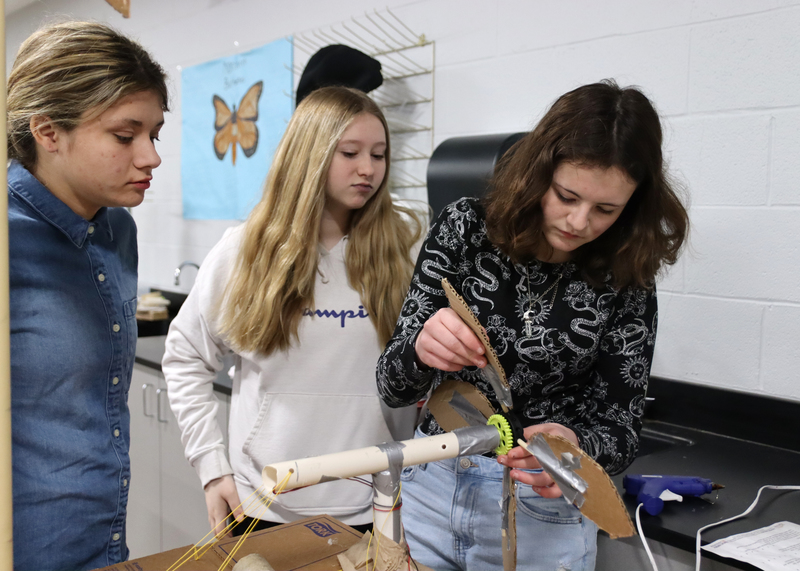 Eighth Graders Kailyn Budke, Kaylee Smoots, Callen Murray work on their windmill together. Photo by Abby Jones