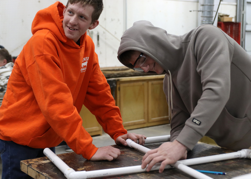 Sophomores Chaz Smith and Andrew Tracy build the base for their windmill. Photo by Abby Jones